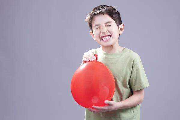 Boy gets air blast from balloon. — Stock Photo, Image