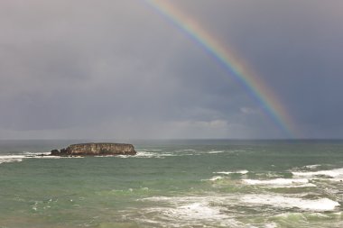 Rainbow over the ocean. clipart