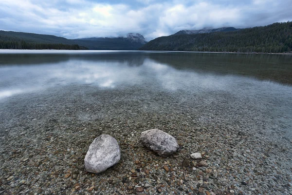 Two rocks in the shallow lake. — Stock Photo, Image