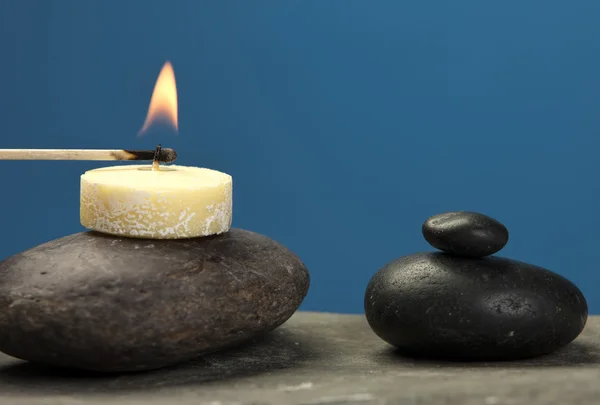 Lighting a small candle on rock. — Stock Photo, Image