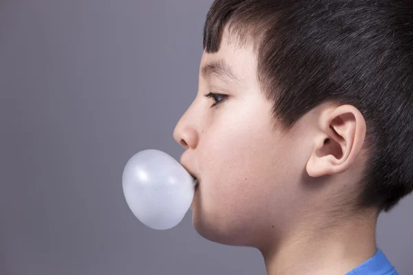 Close up of boy blowing bubble. — Stock Photo, Image