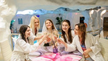 Kaplıca salonundaki bekârlığa veda partisinde gülümseyen kadınların fotoğrafını çek.