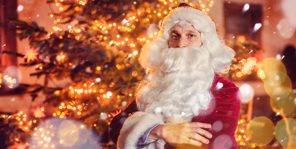 Santa Claus posing in front of a Christmas tree — Stock Photo, Image