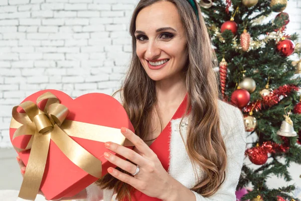 Woman with heart shaped gift on Christmas — Stock Photo, Image