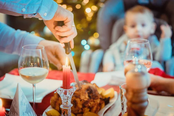 Man of the house cutting traditional Christmas food — Stock Photo, Image