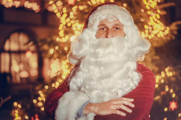 Santa Claus posing in front of a Christmas tree — Stock Photo, Image