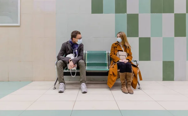 Persone con maschera viso in attesa di un treno nella stazione della metropolitana — Foto Stock