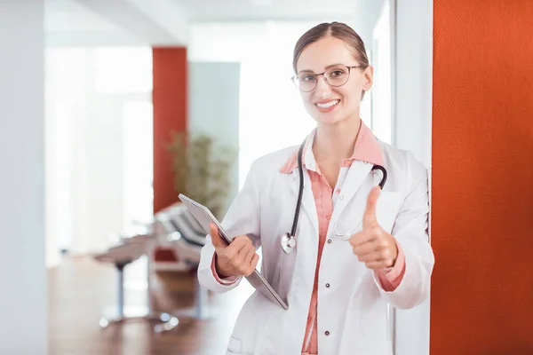 Doctor woman in her practice giving a thumbs up