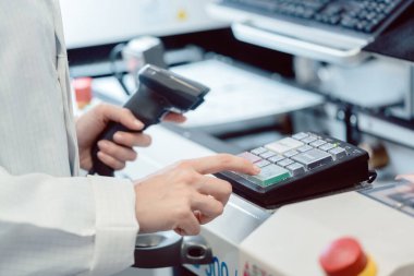 Fabrika işçisi bir makinedeki Tamam düğmesine basıyor