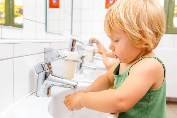 Child in kindergarten washing her hands — Stock Photo, Image