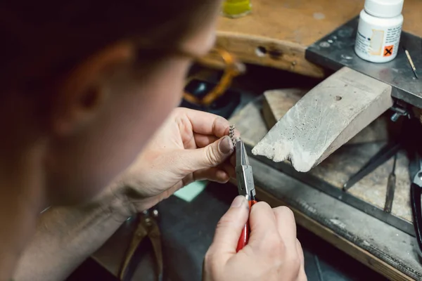 Fleißiger Juwelier arbeitet an einer Kette, die einige Glieder abschneidet — Stockfoto