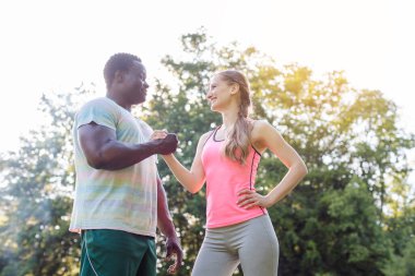 Black-white couple getting some motivation for sport exercise