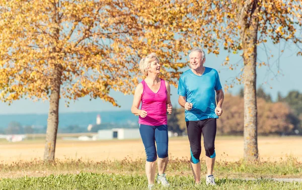 Senior žena a muž běží dělat fitness cvičení — Stock fotografie