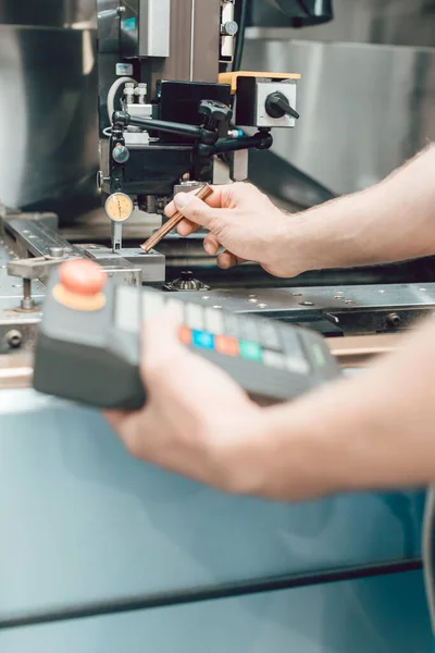 Worker in factory putting tool into a punching machine — Stock Photo, Image