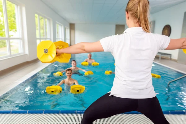 Teacher or coach in water gymnastics class