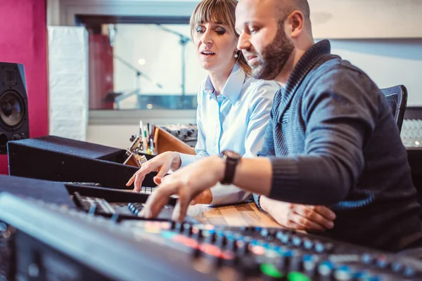 Sound engineer and singer or musician discussing the mix — Stock Photo, Image