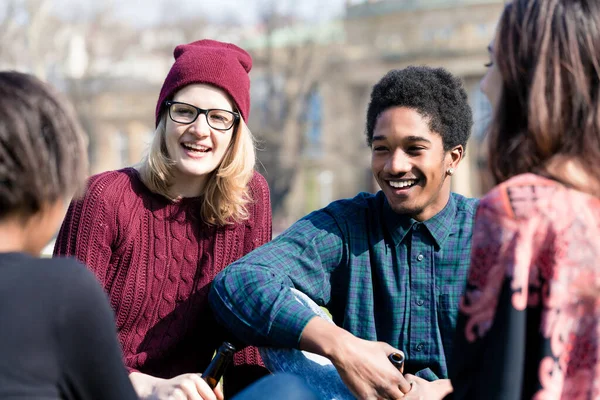 Diverse friends sitting together in the park — Stock Photo, Image