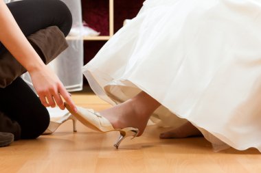 Bride at the clothes shop for wedding dresses