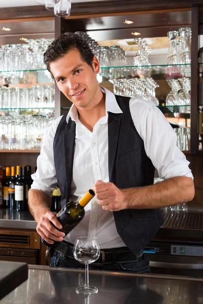 Barman standing behind bar — Stock Photo, Image