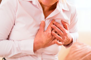 Senior woman having heart attack clipart