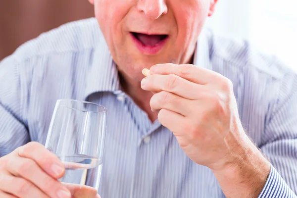 Senior taking overdoses pills — Stock Photo, Image