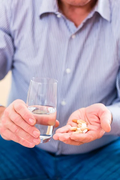 Senior taking overdoses pills — Stock Photo, Image