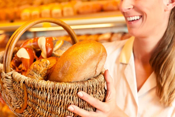 Female baker selling bread — Stock Photo, Image