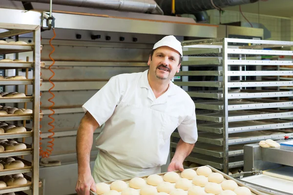 Male baker baking bread rolls — Stock Photo, Image