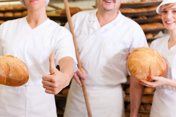 Baker com sua equipe na padaria — Fotografia de Stock