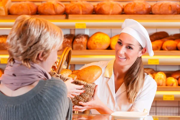 Salesperson with female customer in bakery Stock Photo