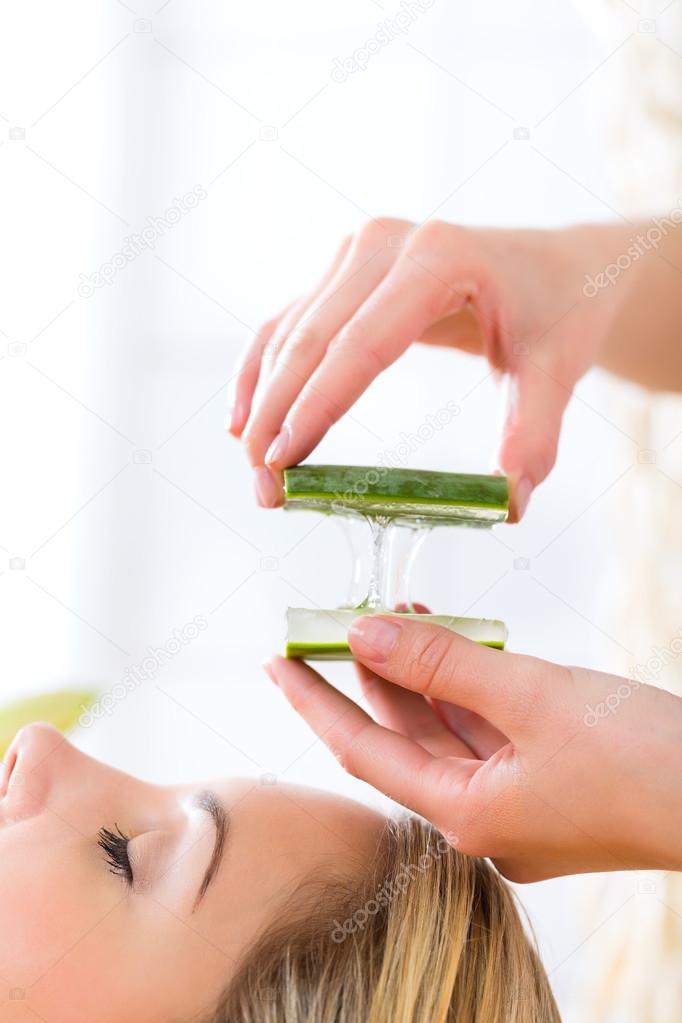 Woman having aloe vera application