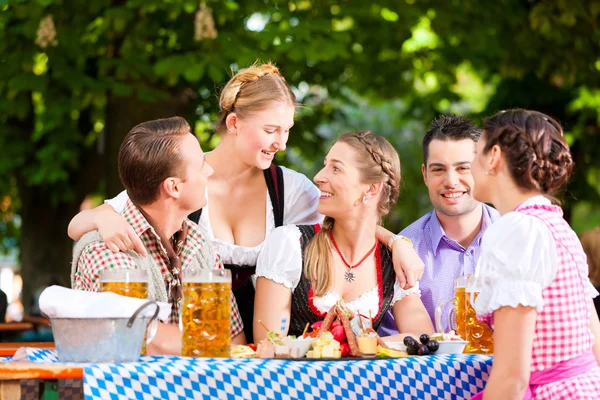 Friends on a table with beer — Stock Photo, Image