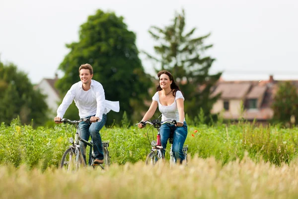 Man and woman cycling in summer Stock Image