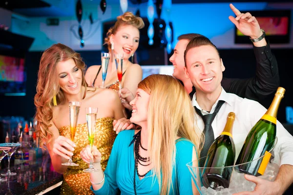 People in club or bar drinking champagne — Stock Photo, Image