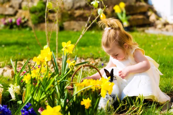 Girl on Easter egg hunt with eggs — Stock Photo, Image