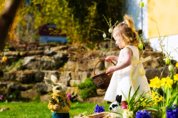 Girl on Easter egg hunt with eggs — Stock Photo, Image