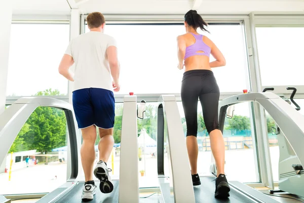 People in sport gym on treadmill running — Stock Photo, Image