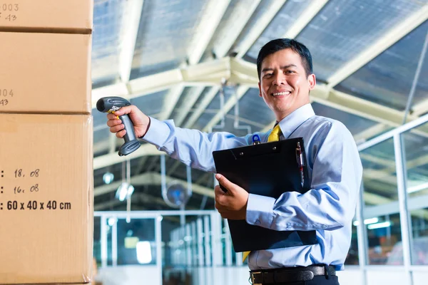 Indonesian Man in warehouse with Scanner — Stock Photo, Image