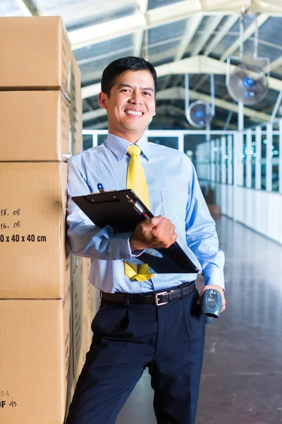 Indonesian worker in warehouse with Scanner — Stock Photo, Image