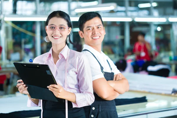 Production manager and designer in Asian factory — Stock Photo, Image