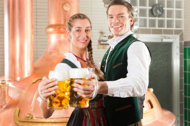 Man and woman with beer glass in brewery clipart
