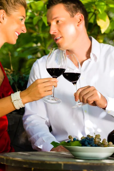 Frau und Mann im Weinberg trinken Wein — Stockfoto