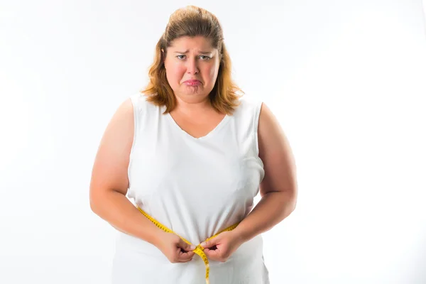 Woman measuring her waist with tape — Stock Photo, Image