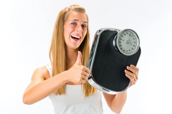 Fiatal nő, kilogramm skála — Stock Fotó