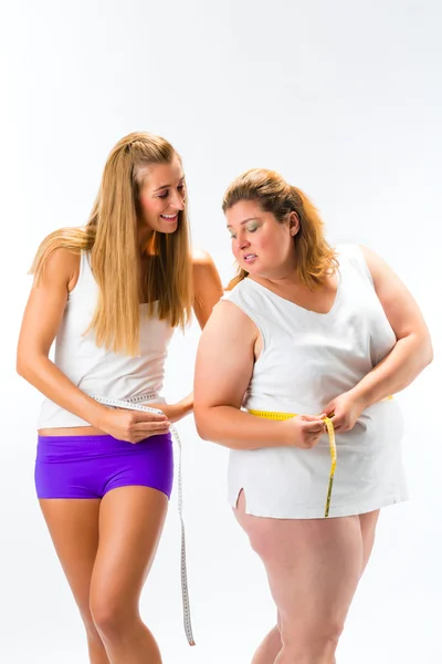 Women measuring waist with tape — Stock Photo, Image