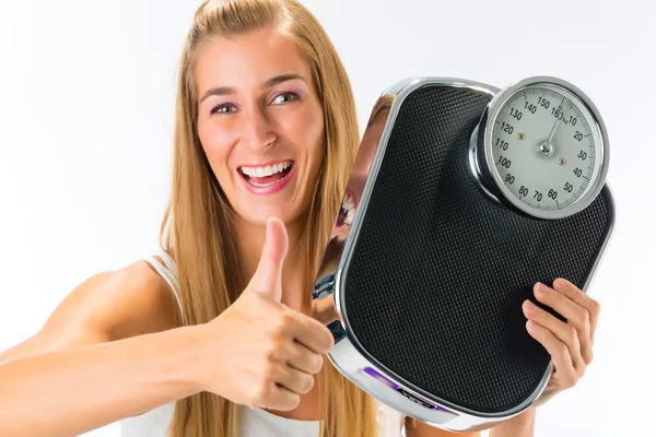 Junge Frau mit Gewichtswaage — Stockfoto