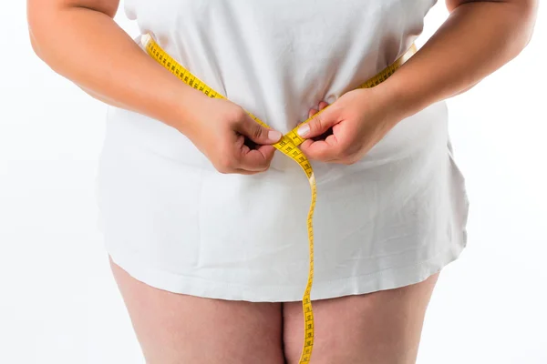 Woman measuring her waist with tape — Stock Photo, Image