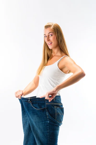 Woman on diet with oversized pants — Stock Photo, Image