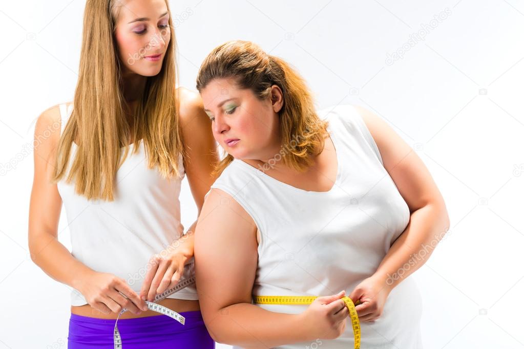 Women measuring waist with tape
