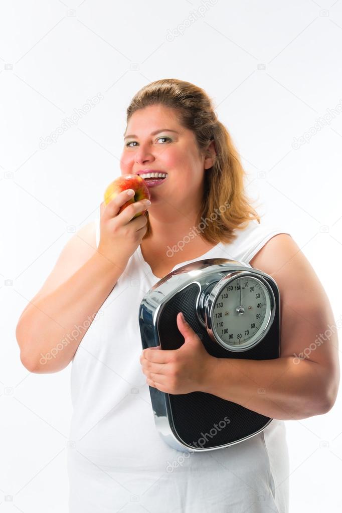 Obese woman with scale  and apple